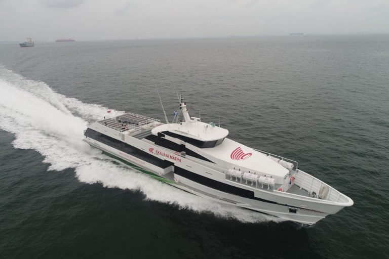 Fast boat traveling from Bali to Lombok over calm blue waters