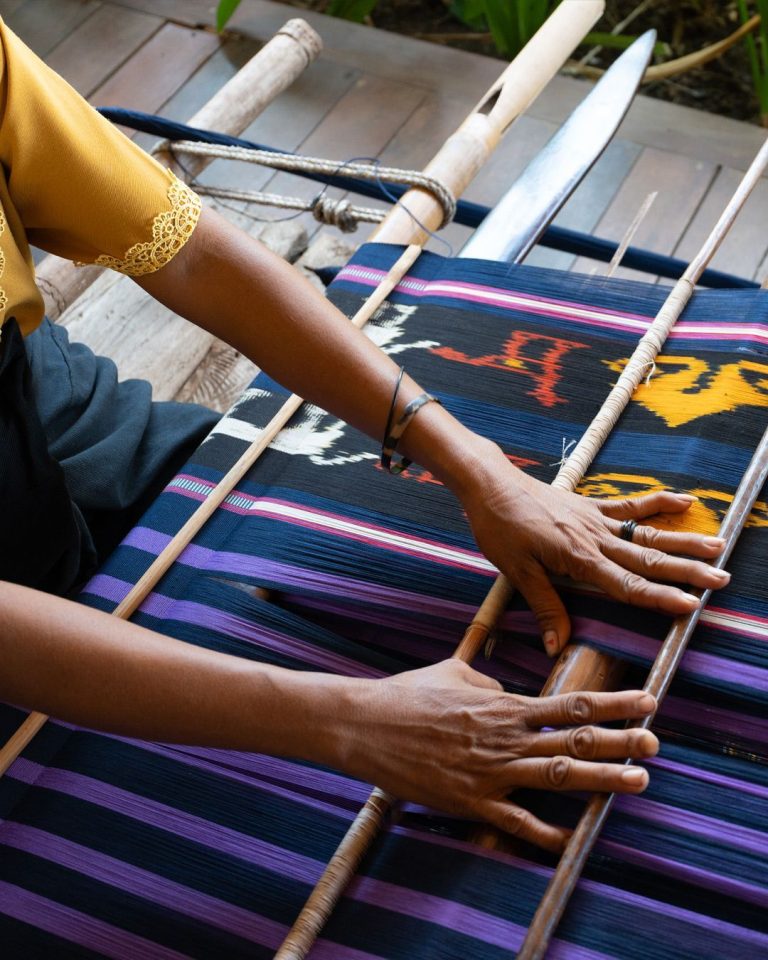 Sumba woman weaving traditional ikat textile on a backstrap loom